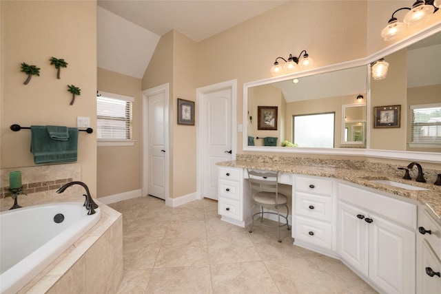 bathroom featuring a garden tub, vaulted ceiling, vanity, and tile patterned floors