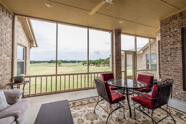 sunroom featuring wood ceiling and ceiling fan