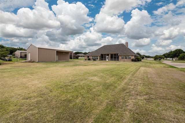 view of yard with a garage, a pole building, and an outdoor structure