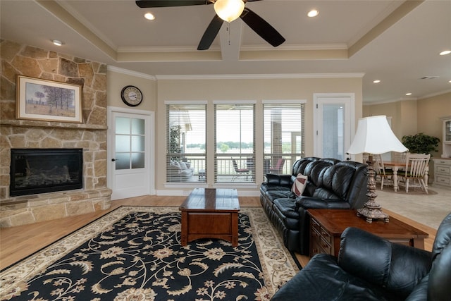 living room with ceiling fan, ornamental molding, a fireplace, and recessed lighting