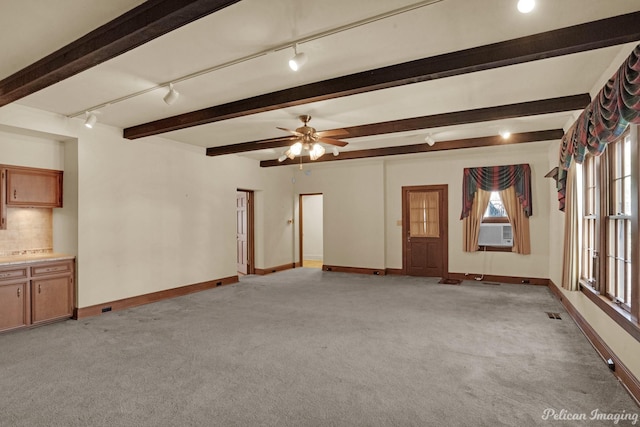 unfurnished living room with cooling unit, ceiling fan, track lighting, and light colored carpet