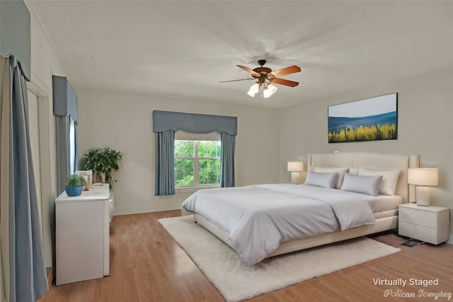 bedroom with ceiling fan and light hardwood / wood-style flooring