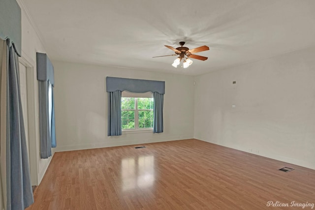 empty room with light hardwood / wood-style floors and ceiling fan