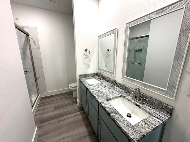 bathroom with walk in shower, toilet, vanity, and hardwood / wood-style flooring