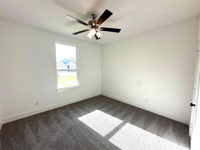 empty room with ceiling fan and dark carpet