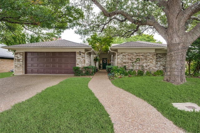 ranch-style house featuring a front yard and a garage