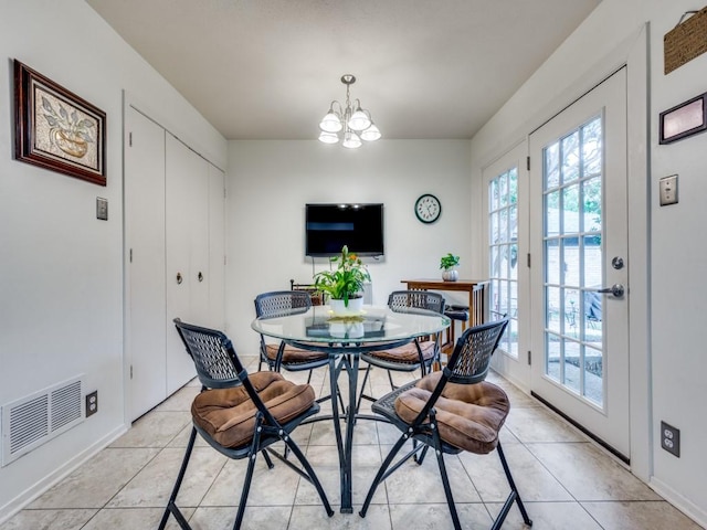 dining space featuring an inviting chandelier and light tile patterned flooring