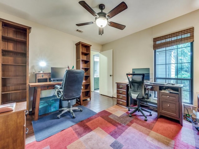 office area featuring dark carpet and ceiling fan