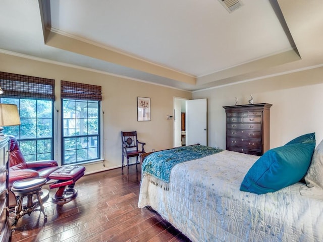 bedroom featuring a raised ceiling, crown molding, and dark hardwood / wood-style floors