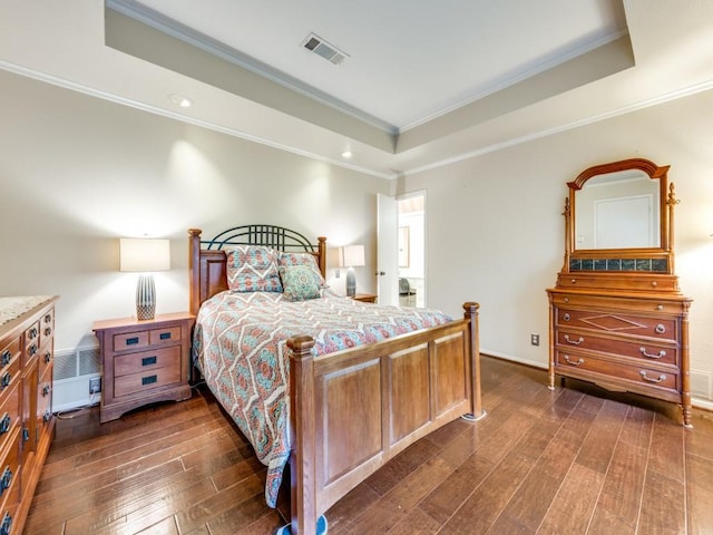 bedroom featuring ornamental molding, a raised ceiling, and dark hardwood / wood-style floors