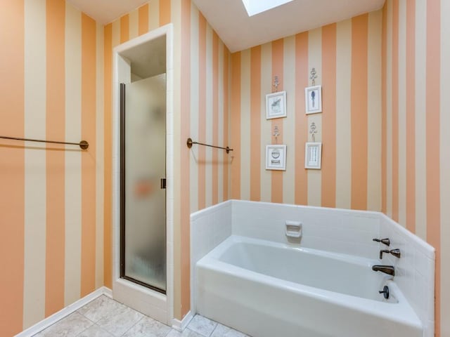 bathroom with shower with separate bathtub and tile patterned floors