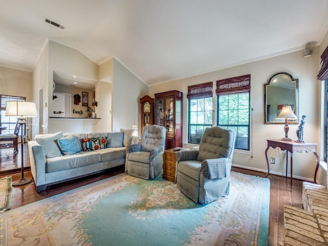 living room featuring lofted ceiling and hardwood / wood-style floors