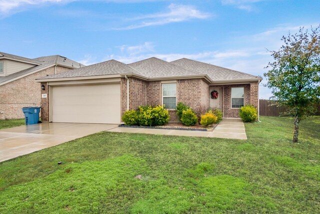 single story home featuring a garage and a front lawn