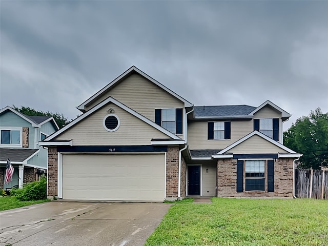 view of front of property with concrete driveway, brick siding, fence, and a front lawn