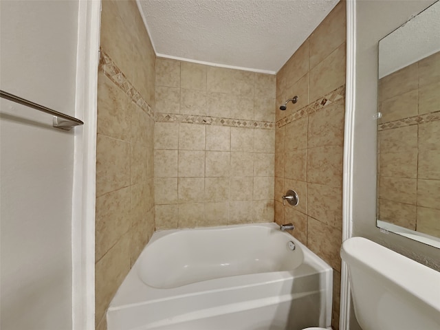 full bath featuring tub / shower combination, a textured ceiling, and toilet