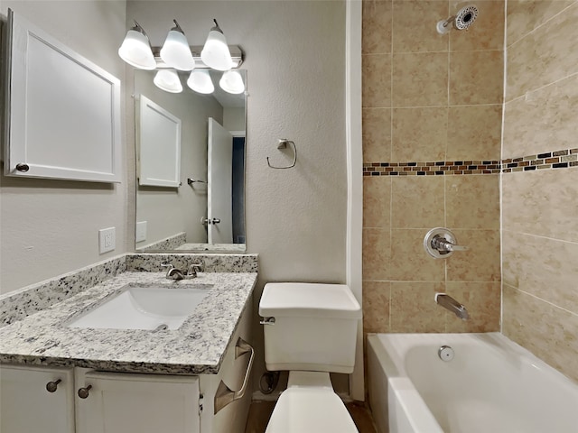 full bath with toilet, a textured wall, vanity, and washtub / shower combination