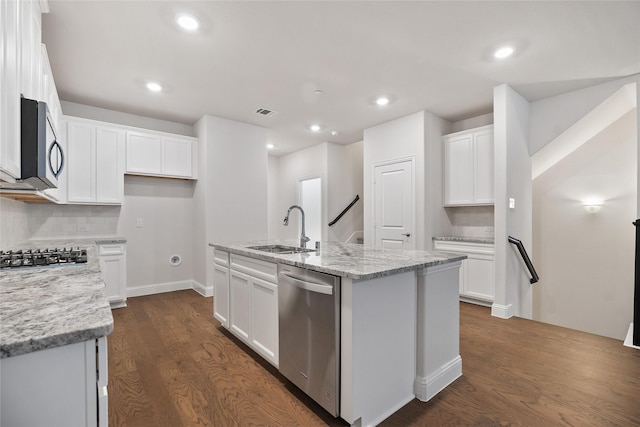 kitchen featuring a kitchen island with sink, sink, white cabinets, and stainless steel appliances