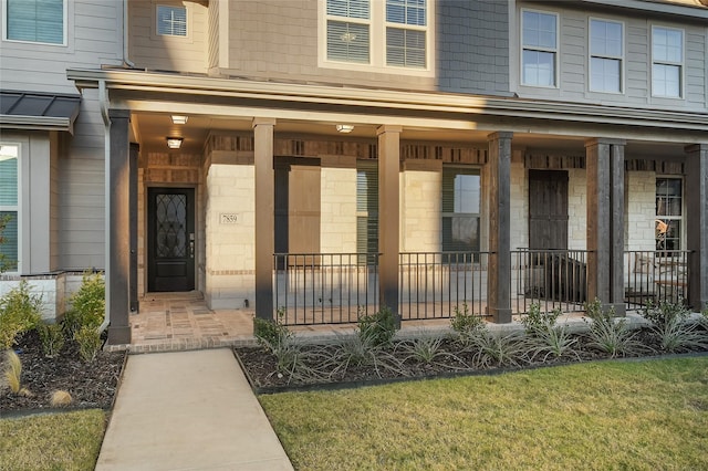 view of exterior entry with a porch