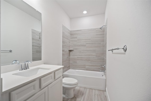 full bathroom featuring vanity, toilet, and tiled shower / bath combo