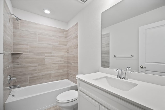 full bathroom featuring tiled shower / bath combo, toilet, and vanity