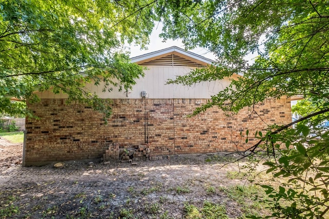 view of property exterior featuring brick siding