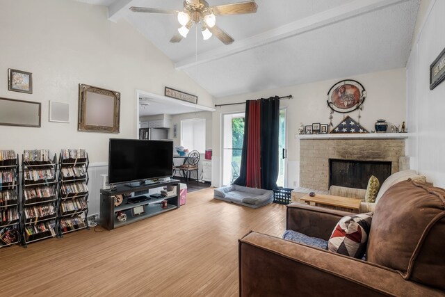 living room featuring a fireplace, wood-type flooring, ceiling fan, high vaulted ceiling, and beam ceiling