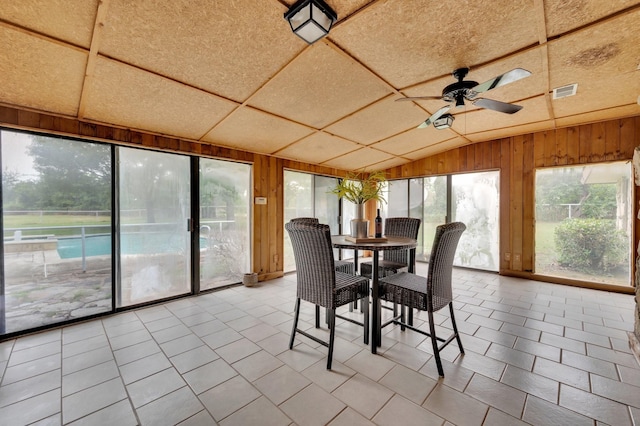 unfurnished sunroom with visible vents, vaulted ceiling, and ceiling fan