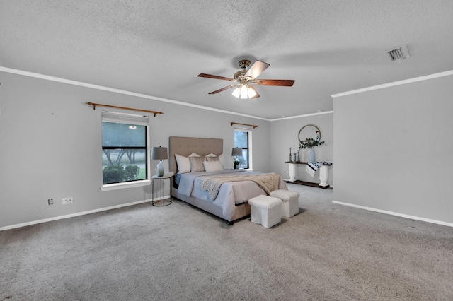 bedroom with carpet, visible vents, a textured ceiling, and baseboards