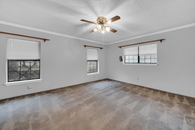 carpeted empty room featuring a ceiling fan, ornamental molding, and a textured ceiling