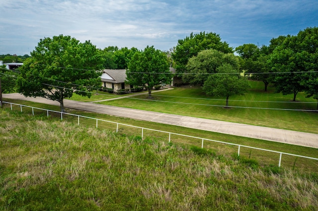 view of yard featuring fence and a rural view