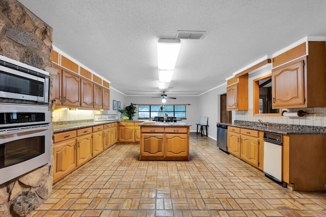 kitchen with visible vents, appliances with stainless steel finishes, decorative backsplash, and ornamental molding