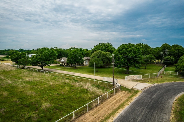 view of property's community with a rural view and fence