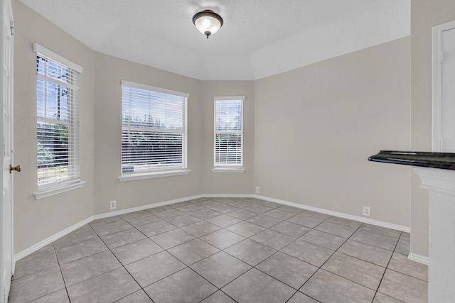 interior space with light tile patterned flooring and a healthy amount of sunlight