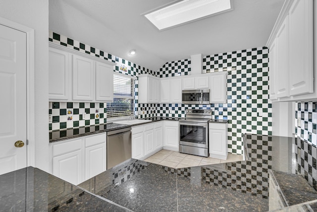 kitchen featuring white cabinets, tasteful backsplash, and appliances with stainless steel finishes