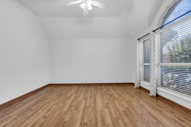 unfurnished room with lofted ceiling, light hardwood / wood-style flooring, and ceiling fan