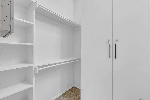 walk in closet with light tile patterned flooring