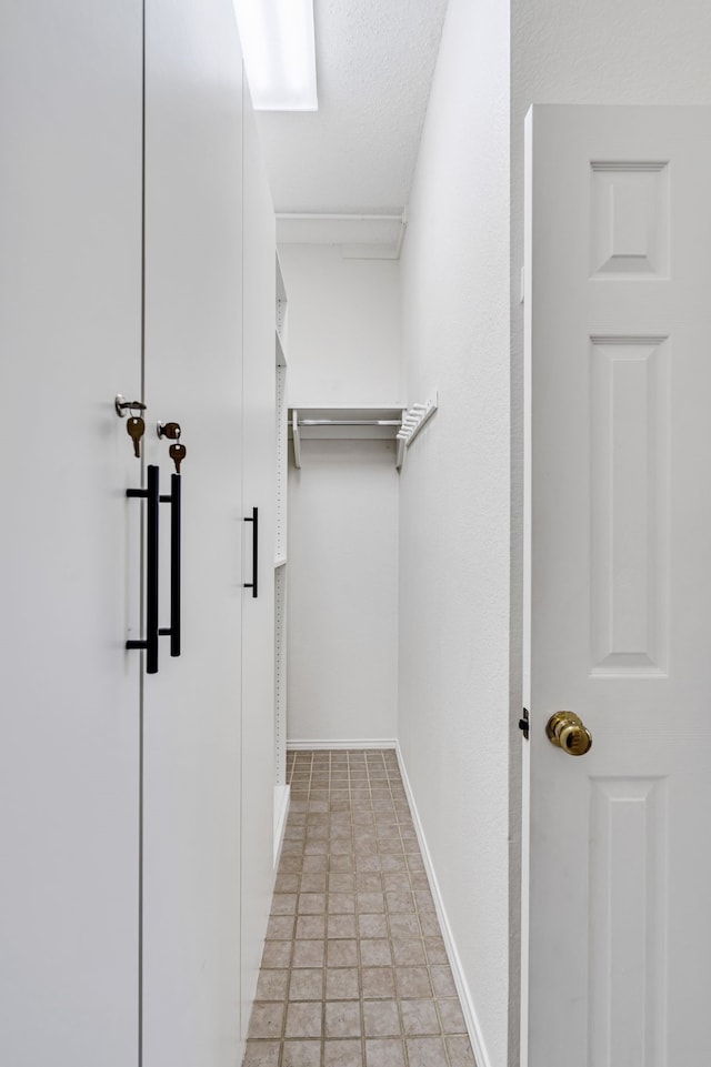 spacious closet with light tile patterned floors