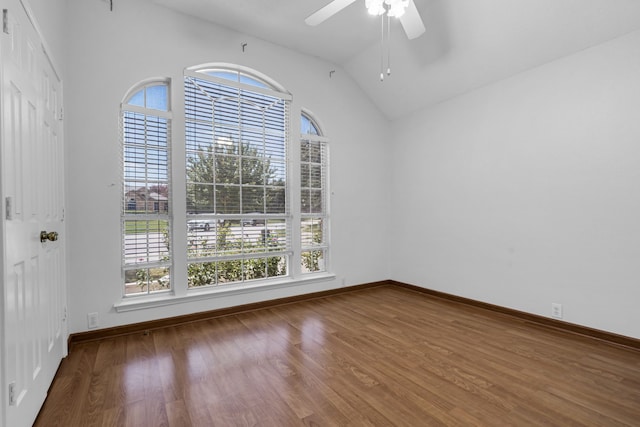 spare room featuring wood-type flooring, ceiling fan, and vaulted ceiling