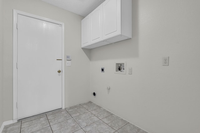 laundry room with hookup for a washing machine, cabinets, electric dryer hookup, and light tile patterned floors