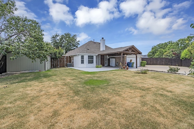 rear view of property featuring a lawn