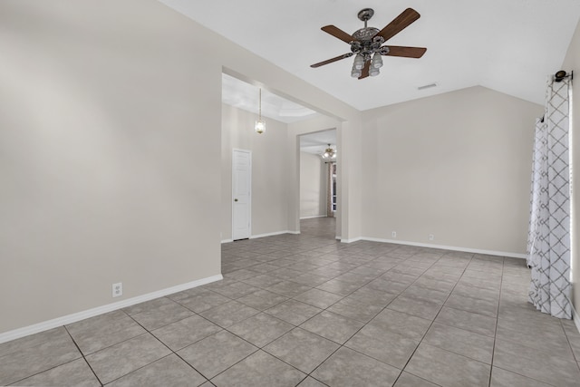 tiled spare room with lofted ceiling and ceiling fan