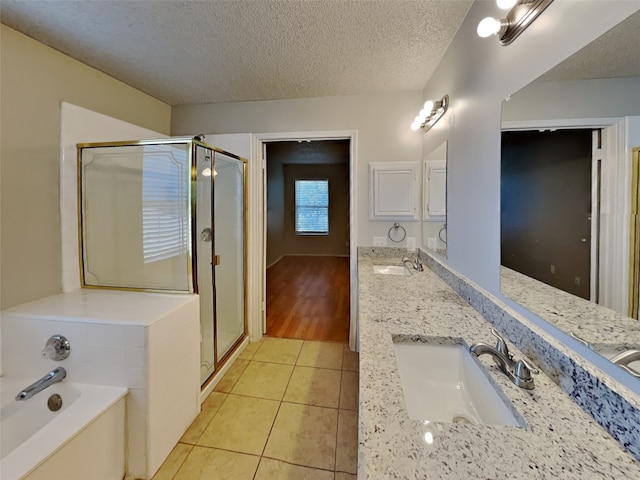 bathroom featuring double vanity, walk in shower, a textured ceiling, and hardwood / wood-style flooring