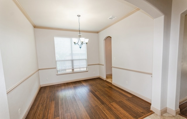 spare room featuring a healthy amount of sunlight, crown molding, and hardwood / wood-style floors