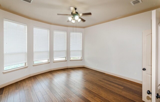 spare room with dark hardwood / wood-style flooring, ornamental molding, and ceiling fan