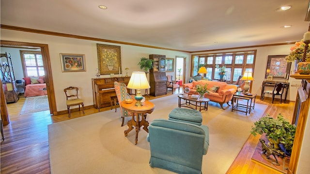 living room featuring light hardwood / wood-style flooring and ornamental molding