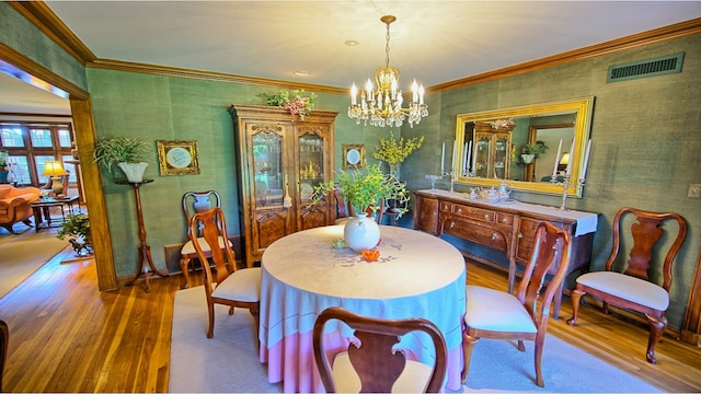 dining room with a notable chandelier and hardwood / wood-style floors