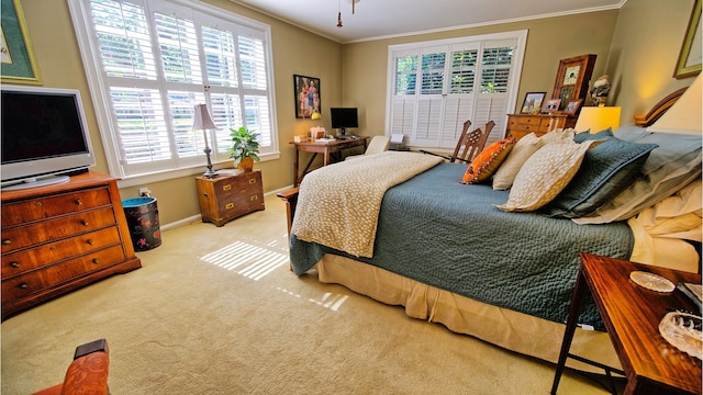 bedroom featuring crown molding and light carpet