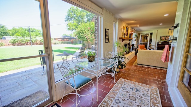 sunroom featuring a large fireplace