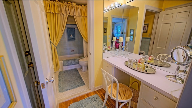 bathroom featuring vanity, hardwood / wood-style floors, and toilet