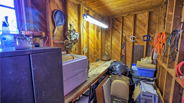 miscellaneous room featuring wood walls